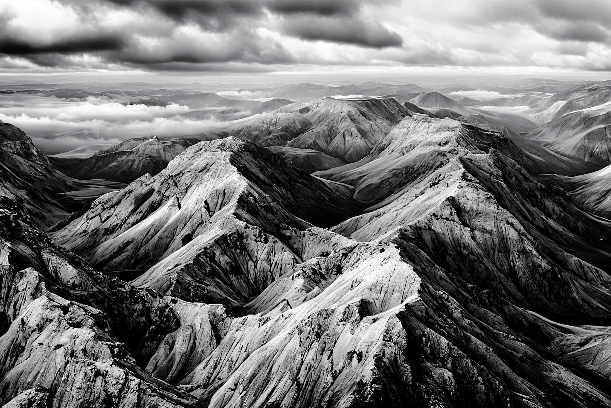 Veiled peaks serenade: Captivating aerial landscape art with breathtaking aerial scenery, in a room with minimalist approach, framed art, and decorative pieces. The art can be printed on poster, framed poster, canvas, metal, acrylic or wood, exclusively at WallArtZen. Find this exact print at https://wallartzen.com/waz125
